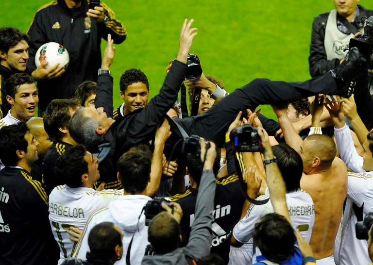 Real Madrid's coach Jose Mourinho is thrown in the air by his players after their win over Athletic Bilbao to win the Spanish first division league title at San Mames stadium in Bilbao May 2, 2012. REUTERS/Vincent West (SPAIN - Tags: SPORT SOCCER)