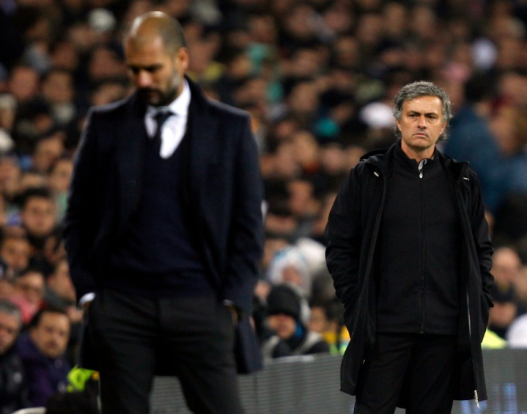 10 Dec 2011, Madrid, Spain --- Real Madrid&apos;s coach Jose Mourinho (R) looks at Barcelona coach Pep Guardiola after Xavi Hernandez goal during their Spanish first division soccer match, the Clasico, at the Santiago Bernabeu stadium in Madrid, December 10, 2011. REUTERS/Sergio Perez (SPAIN - Tags: SPORT SOCCER) --- Image by Â© SERGIO PEREZ/Reuters/Corbis